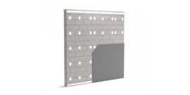 Masonry wall with cavity insulation holes and partially installed gypsum board, illustrating thermal insulation.